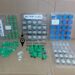 fiber optic adapters placed loosely on a cardboard surface, displaying different models i.e. LC/APC LC/UPC SC/APC duplex adapters connector types